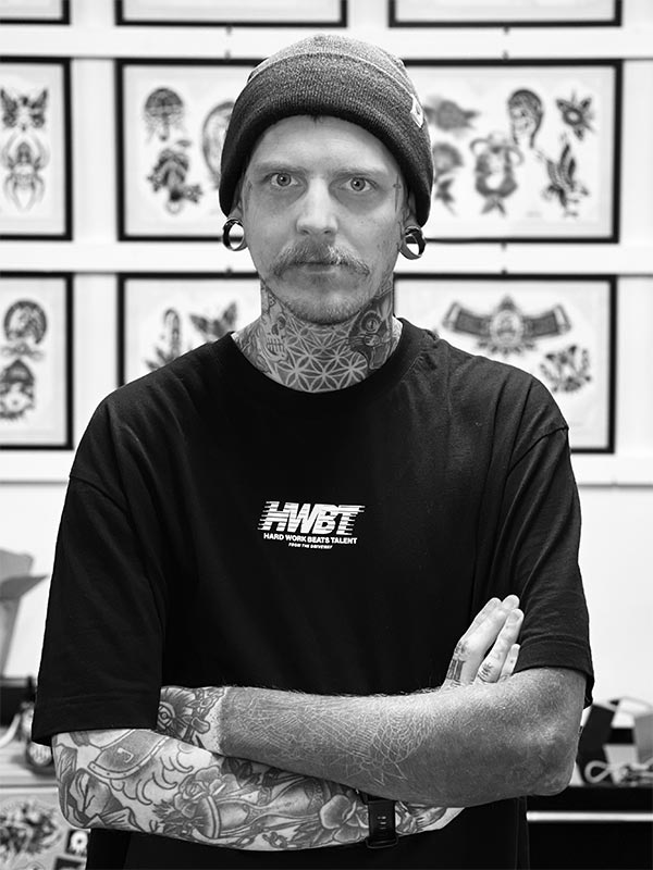 Russ Pierce stood in front of his wall of flash designs